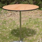 A round table featuring a sturdy metal base and a polished wooden top, elegantly designed for modern interiors.